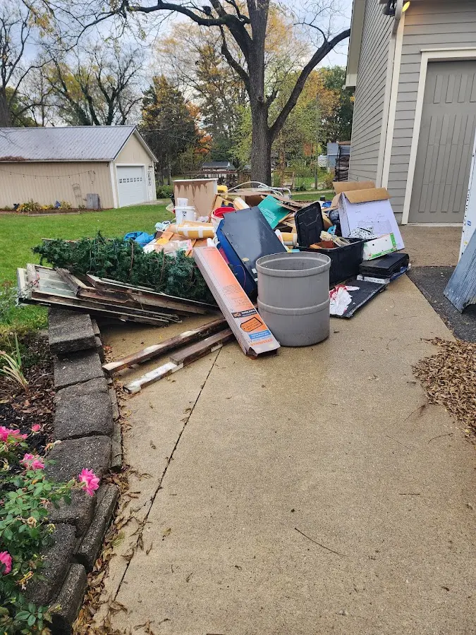 Dumpster being loaded with debris for Estate Cleanout Dumpster Rental in Arnold